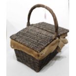 A wicker basket with double hinged cover