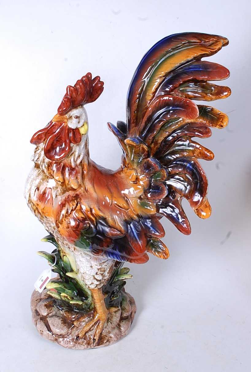 A large 20th century Continental glazed model of a cockerel, in standing pose on naturalistic