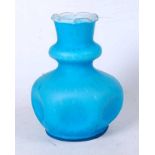 An early 20th century blue glass vase, the knopped neck over a dimpled body, standing on a