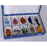 A boxed set of ten modern Chinese snuff bottles with stoppers, in various shapes to include fish,