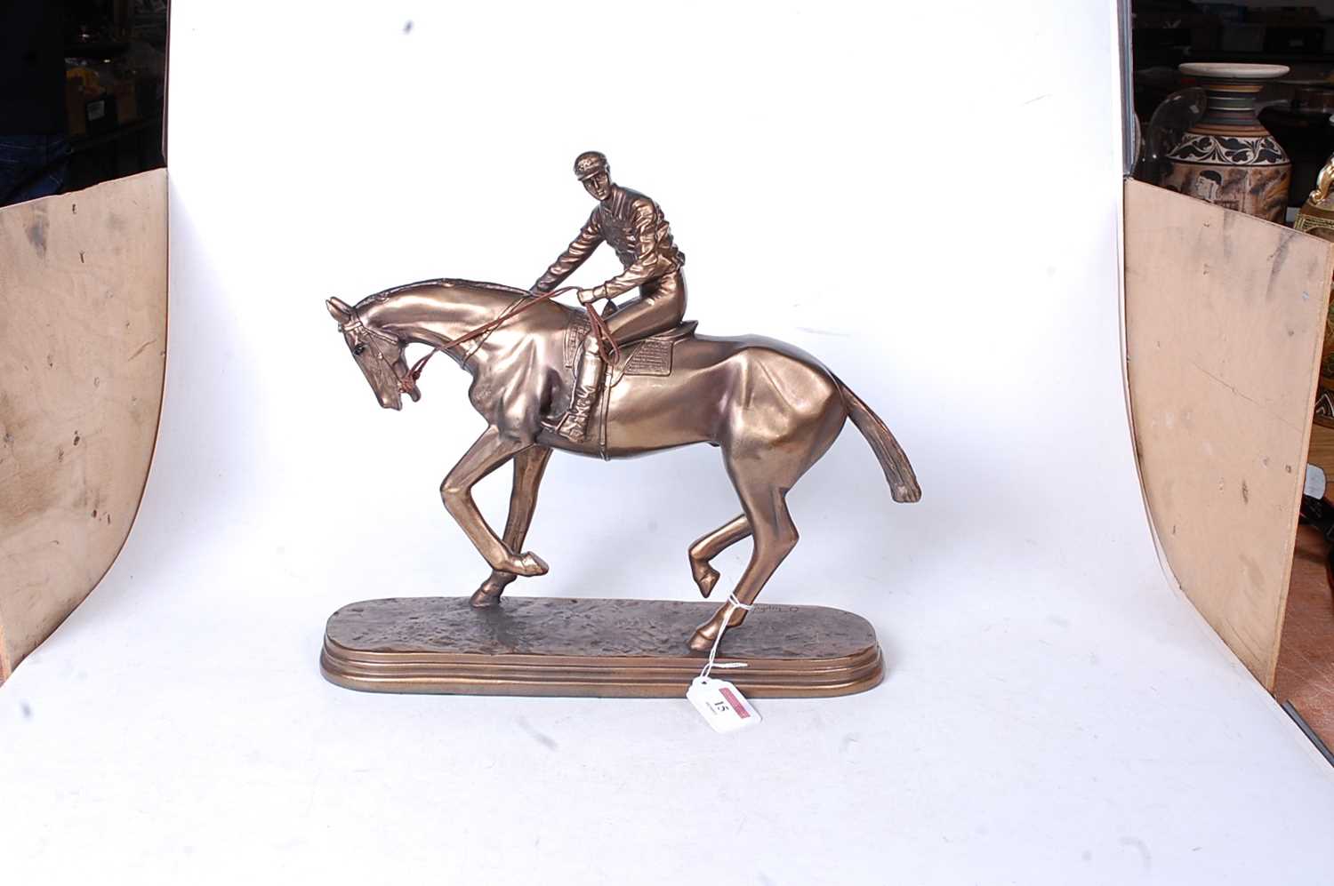 A reproduction bronzed resin figure of a racehorse and jockey, on naturalistic oval plinth, h.32cm - Image 2 of 3