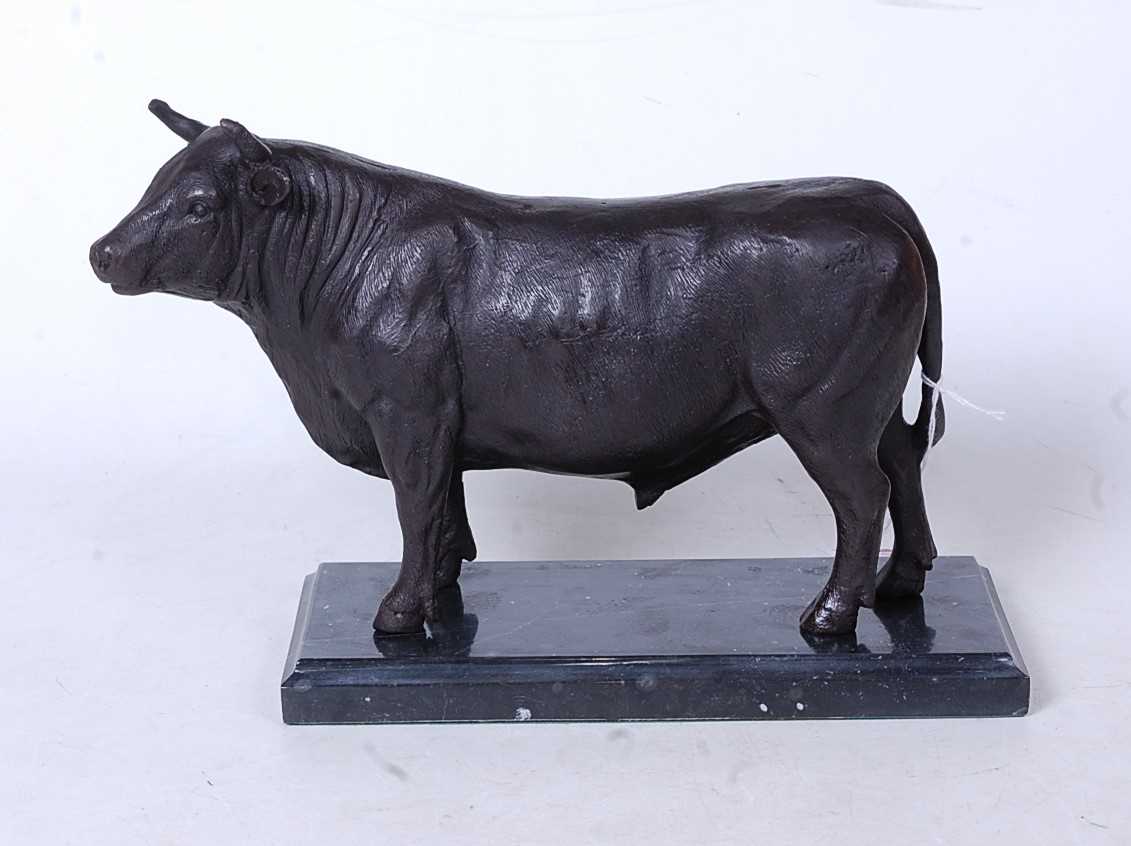 A bronze model of a bull in standing pose on marble plinth, height 19cm