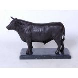 A bronze model of a bull in standing pose on marble plinth, height 19cm