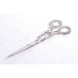 A pair of Victorian silver wick scissors, the handles cast with leaves and berries, maker probably