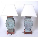 A pair of Chinese bronze table lamps, of square section, having incised Greek Key type decoration