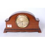 A 1920s mahogany cased mantel clock, having engine turned dial with Arabic numerals and French
