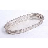 A George V silver pen tray of oval form with pierced gallery and beaded rim, hall marks rubbed,