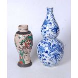 A Chinese export blue and white double-gourd vase, decorated with dragons amidst flowers and