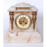 A late Victorian alabaster cased mantel clock, of architectural form with Egyptian revival type gilt