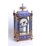 A reproduction gilt brass and enamel four glass mantel clock, having an unsigned polychrome