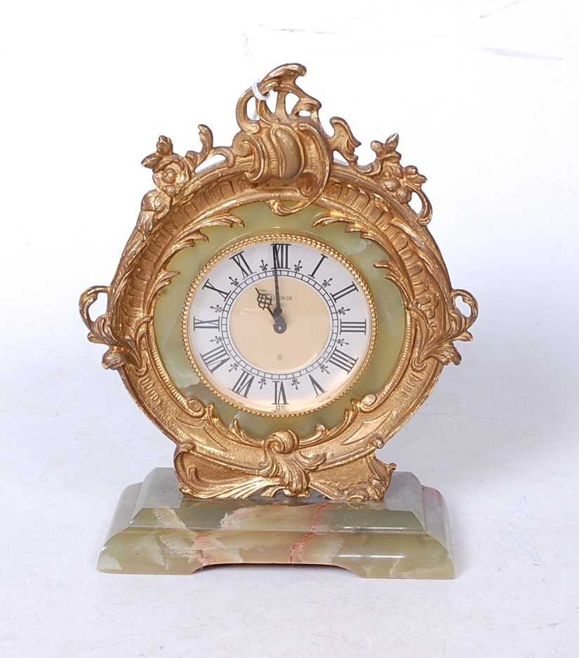 A Rococo style green onyx and gilt metal mounted mantel clock, the circular dial with Roman numerals