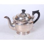 A mid-20th century silver teapot, of plain undecorated form, having ebonised finial and handle, by