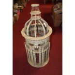 A reproduction painted softwood and wirework birdcage, of cylindrical form, h.84cm
