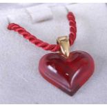 A Lalique cranberry glass heart shaped pendant on finely woven rope twist necklace in fitted