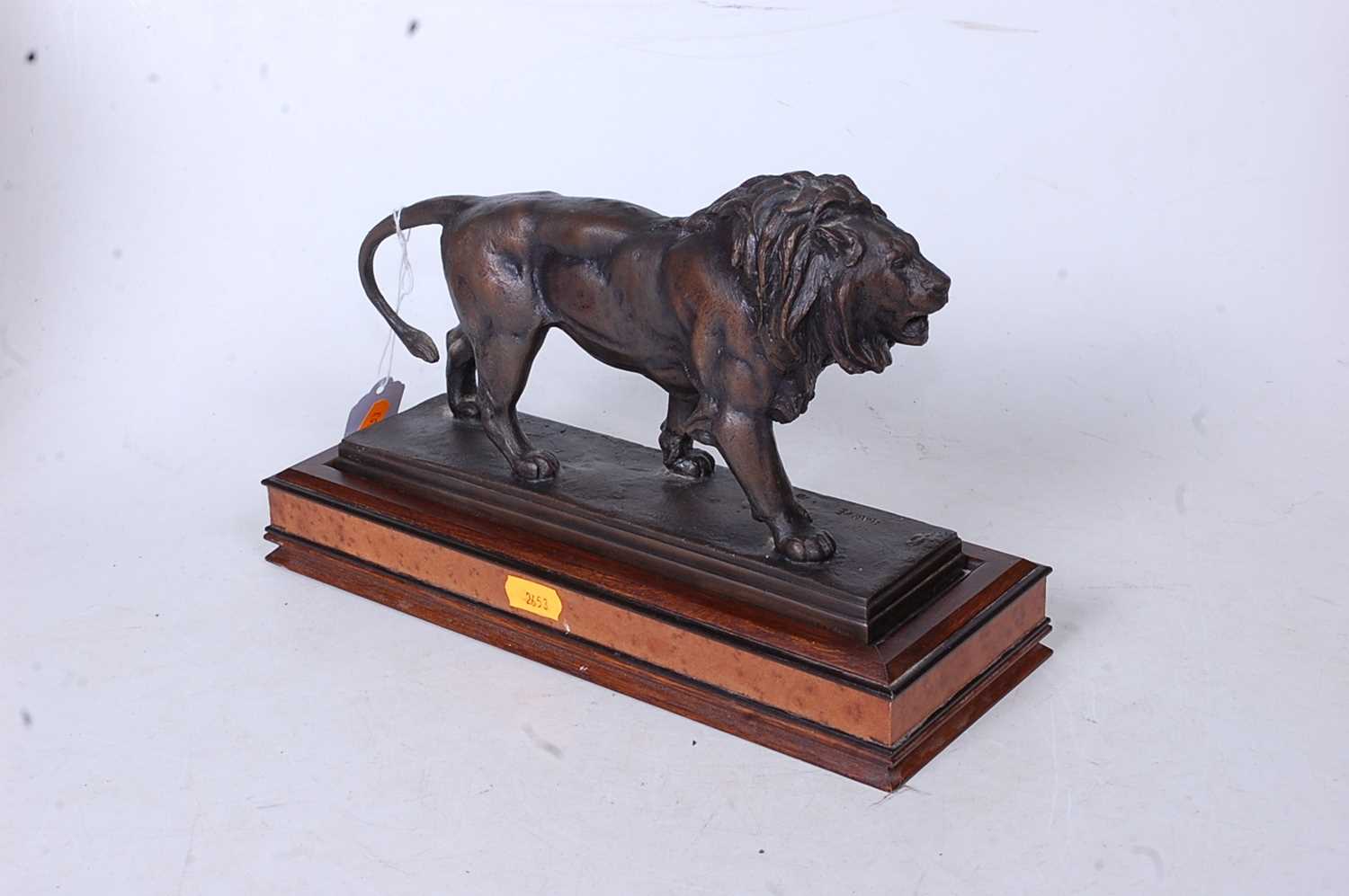 After Antoine Louis Bayre - a bronzed metal model of a lion in stalking pose, on a rectangular - Image 2 of 2