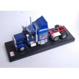 A Revell model of a Peterbuilt 359 truck on rectangular plinth