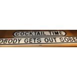 A painted cut-out wooden sign 'Cocktail Time', w.85cm; and one other 'Nobody Gets Out Sober' (2)