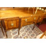 A George IV mahogany, flame mahogany, and ebony strung breakfront sideboard, having single central