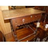 A provincial antique joined oak single drawer side table, raised on turned and square cut