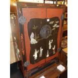 A contemporary Chinese black lacquered hardstone inset low double door side cupboard, w.61.5cm