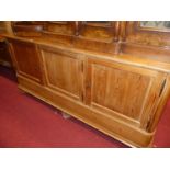 A 19th century Continental rustic stained pine round cornered three door side cupboard, raised on