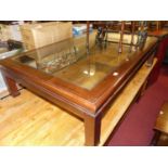 A contemporary hardwood and clear glass inset low rectangular coffee table, length 146cm; together