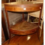 A 19th century mahogany bowfront two-tier corner washstand, having hinged upper action