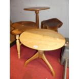 An antique pine low tripod table; together with a blond oak tripod table; a contemporary elm seat