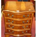 A small reproduction yew wood serpentine front bedside chest, of four long drawers, w.41.5cm