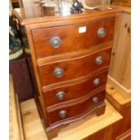 A reproduction yew wood four drawer serpentine bedside chest, width 46cm