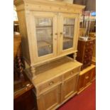 A rustic reclaimed pine French kitchen dresser, having twin door glazed upper section over base