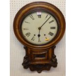 A mid-Victorian carved oak droptrunk wall clock, the white enamel dial with twin winding holes, with