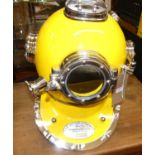 A contemporary chromed metal and yellow painted diver's helmet