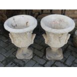 A pair of reconstituted stone pedestal urn garden planters, each h.56cm, dia.39cm