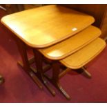 A 1980s teak nest of three occasional tables, the largest w.57cm