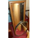 An oak framed rectangular wall mirror, together with an Edwardian brass framed oval bevelled wall