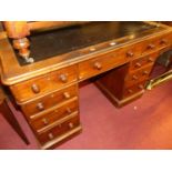 A Victorian mahogany round cornered twin pedestal writing desk, having a rexine inset surface over