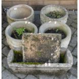 Four reconstituted stone circular garden planters, each dia.30cm; together with a similar trough