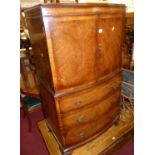 A figured walnut bowfront compactum side cabinet, having twin upper doors over three long drawers to