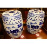 A pair of contemporary Chinese style blue & white glazed ceramic barrel garden seats, each height
