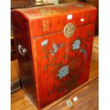 A contemporary Chinese red lacquered and floral gilt decorated domed hinge topped travel chest,