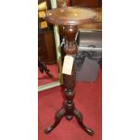 A floral carved mahogany pedestal plant stand, having slightly raised circular top, h.107.5cm