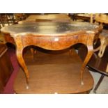 A circa 1900 French figured walnut and brass mounted shaped top single drawer writing table,