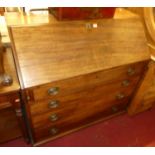 An early 19th century mahogany slopefront writing bureau, having satinwood lined and fitted