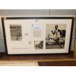A framed display of cuttings commemorating British athlete McDonald Bailey's achievement in