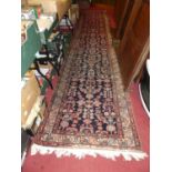 A Persian woollen blue ground Shiraz long hall runner, 490 x 100cm