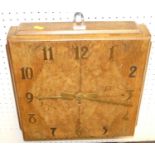 An Art Deco figured walnut square wall clock, with brass hands and numerals, single winding hole, 39