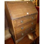 An early 20th century mahogany slopefront three drawer writing bureau, on cabriole supports, w.64cm