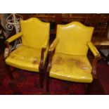 A pair of mahogany framed and leather upholstered Gainsborough elbow chairs (wear and damages to
