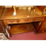 A Victorian mahogany round cornered three drawer two-tier side table, raised on turned and reeded